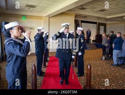 Capt. Christopher Holland, commanding officer of the Los Angeles-class attack submarine USS Boise (SSN 764), renders a salute to sideboys during a change of command ceremony onboard Naval Station Norfolk, Oct. 21, 2022. During the ceremony, Holland relieved Cmdr. Jonathan Cantor as commanding officer of Boise. Stock Photo