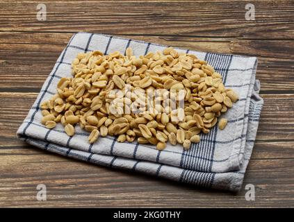 Pealed Peanuts in a bowl isolated on wooden background Stock Photo