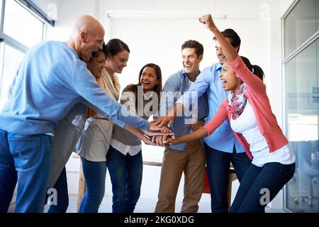 Theres no better work than teamwork. a group of casually dressed businesspeople in the office. Stock Photo
