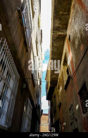 A vertical shot of a street between old medieval stone buildings in ...