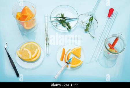 Laboratory glassware with plants and citrus fruits. top view Stock Photo