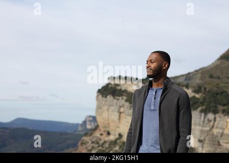 Confident black man contemplating views in the mountain Stock Photo