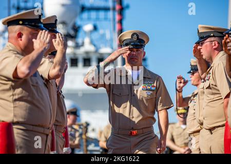 Chief Sonar Technician (Surface) Jacob Todd, assigned to the Arleigh Burke-class guided-missile destroyer USS Ramage (DDG 61), salutes sideboys as a newly pinned Chief Petty Officer (CPO) during a CPO pinning as part of the Gerald R. Ford Carrier Strike Group, Oct. 21, 2022. The first-in-class aircraft carrier USS Gerald R. Ford (CVN 78) is on its inaugural deployment conducting training and operations alongside NATO Allies and partners to enhance integration for future operations and demonstrate the U.S. Navy’s commitment to a peaceful, stable and conflict free Atlantic region. Stock Photo