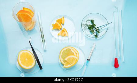 Laboratory glassware with plants and citrus fruits. top view Stock Photo