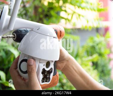 Man installing IP CCTV or high tech surveillance system CCTV system Stock Photo