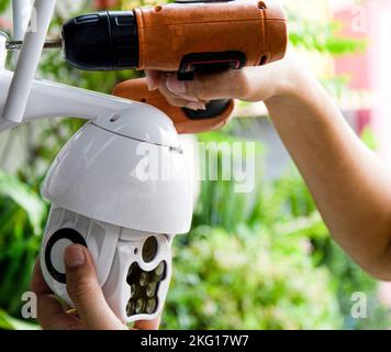 Man installing IP CCTV or high tech surveillance system CCTV system Stock Photo