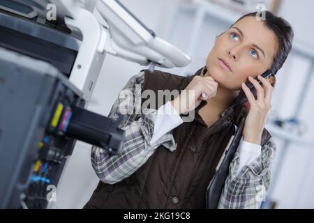 woman fixing cartridge in printer machine Stock Photo