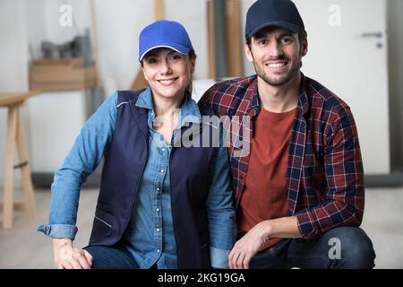 construction workers team of man and woman smiling at camera Stock Photo
