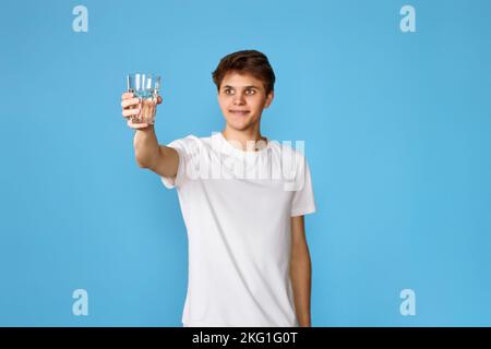 Young handsome man with drinking glass of water Stock Photo