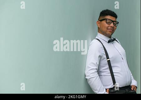 Portrait of young man leaning against wall Stock Photo