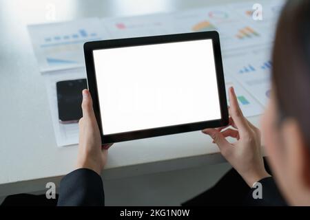 A white screen tablet computer placed on the desk at work. Can put text or media in the area on the white screen. Stock Photo