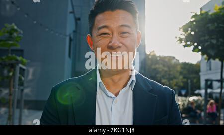 Front view portrait smiling happy Asian middle-aged businessman Korean adult entrepreneur employer man worker manager investor architect standing in Stock Photo