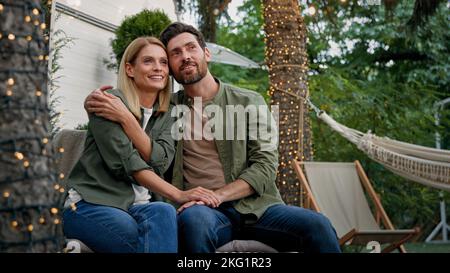 Spouses Caucasian woman and man married couple husband and wife girlfriend and boyfriend outdoors talking planning idea conversation dreaming about Stock Photo