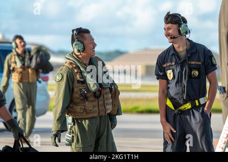 U.S. Air Force Maj. Eric Purkett, 37th Expeditionary Bomb Squadron pilot, left, speaks to Senior Airman Colter Taylor, 28th Aircraft Maintenance Squadron crew chief, both assigned to Ellsworth Air Force Base, South Dakota, prior to boarding a B-1B Lancer at Andersen AFB, Guam, Oct. 24, 2022. Bomber Task Force missions demonstrate lethality and interoperability in support of a free and open Indo-Pacific. Stock Photo