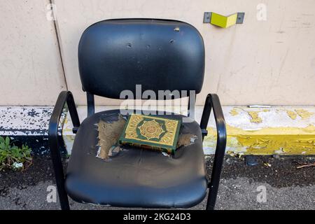 Kuran on a chair in a street in central Beirut, Lebanon Stock Photo