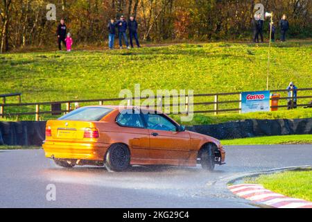 BMW 3 Series; Rear-wheel-drive car, driving on drift tracks and high-speed cornering on wet roads on a Three Sisters Drift Day in Wigan, UK Stock Photo