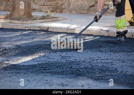asphalt in the city operators working with uniform Stock Photo