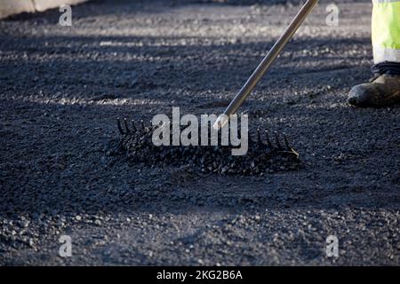 asphalt in the city operators working with uniform Stock Photo