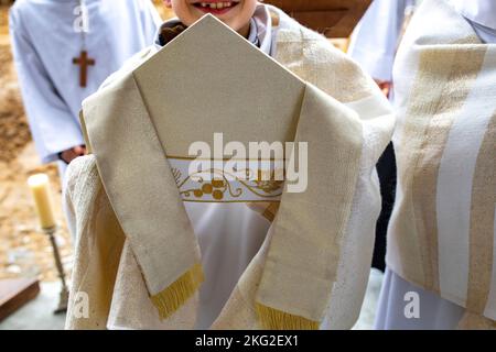 Altar boy holding a bishop's miter in Montigny-Voisins le Bretonneux, France Stock Photo