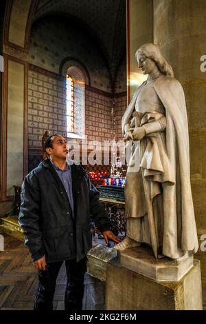 Former muslim converted to christianity praying in Notre-Dame de la Gare catholic church, Paris Stock Photo