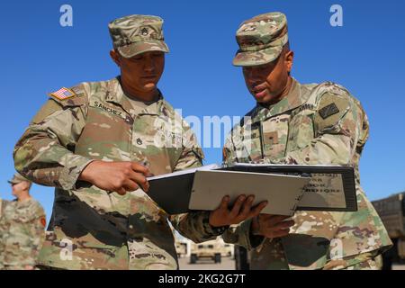U.S. Army Brig. Gen Daryl O. Hood (Right), commanding general, 20th Chemical, Biological, Radiological, Nuclear, Explosives Command, inspecsts dispatch paperwork with U.S. Army Staff Sgt. Christopher Sanchez (Left), 79th Explosive Ordnance Disposal Battalion, 71st Ordnance Group (EOD) during his visit to Fort Riley, Kansas, October 25, 2022. Stock Photo
