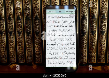 Al-Serkal Mosque.  Digital Quran on a smartphone and traditional paper Holy Quran. Paper and digital Quran.  Phnom Penh. Cambodia. Stock Photo