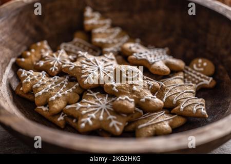 Christmas and New Year gingerbread in a wooden bowl. Stock Photo