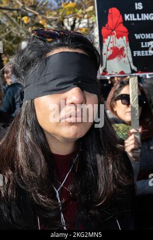 A woman seen wearing a black blindfold as a sign of support for people in Iran and Ukraine. People in Halifax rallied at Peace and Friendship Park Saturday to show support for the people of Ukraine and Iran. Hundreds of supporters held signs and called for action, across the street from defense leaders discussing pressing global security concerns at the Halifax International Security Forum. Organizer Reza Rahimi said he wanted those leaders to hear their voices, especially because so many people living in those countries can't speak to the media. Demonstrators said they wanted to be the voices Stock Photo