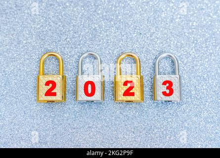 Group of locked steel padlocks reading 2023. The concept of getting things done by the beginning of the new year. Stock Photo