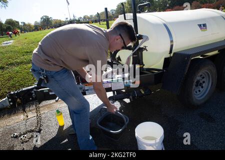 U.S. Marine Corps Sgt. Ryan Donnelly, a Marine Air-Ground Task Force Planning specialist with Plans, Policies and Operations South, fills a bucket with water at Woodlawn Funeral Home and Memorial Garden, VA, Oct. 26, 2022. Marines and civilian volunteers participated in a Single Marine Program event to give back to the community and restore the plaques of fallen veterans. With more than 75 acres of rolling green lawns, Woodlawn provides families with a permanent and peaceful final resting place. Stock Photo