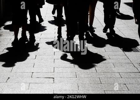 Blurry shadow and silhouette of people walking on the city street ...