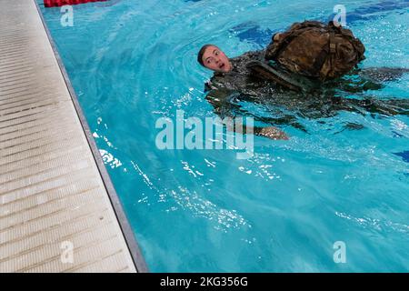 1st Lt. Molly Murphy from Tripler Army Medical Center, swims with her ruck sack and M4 during the Combat Water Survival Test in the 2022 Medical Readiness Command, Pacific Best Medic Competition Wednesday, October 26th 2022 at Joint Base Lewis-McChord. Stock Photo