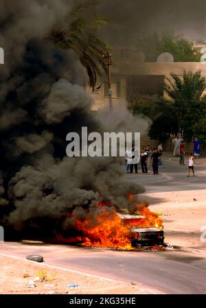 BAGHDAD, IRAQ - 08 August 2006 - An Iraqi vehicle burns in Baghdad, Iraq after being hit by a mortar that was fired by insurgents - Photo: Geopix/US N Stock Photo