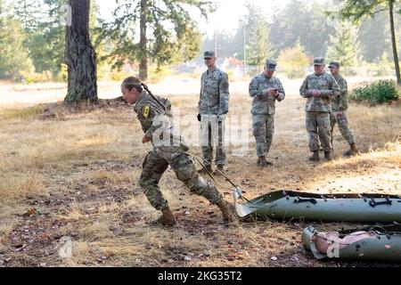 1st Lt. Molly Murphy from Tripler Army Medical Center, pulls the casualty to safety in the 2022 Medical Readiness Command, Pacific Best Medic Competition Wednesday, October 26th 2022 at Joint Base Lewis-McChord. Stock Photo