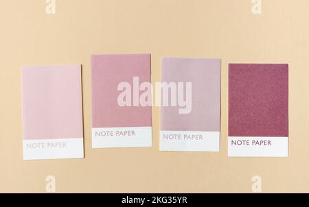 Four colorful blank notes adhesives paper for your text or message on yellow background. Stock Photo