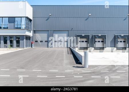 Row of grey industrial Units with roller shutter doors. Stock Photo