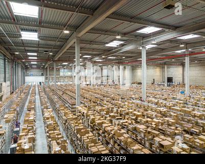A wide shot of rows of shelves with goods boxes in modern industry warehouse store Stock Photo