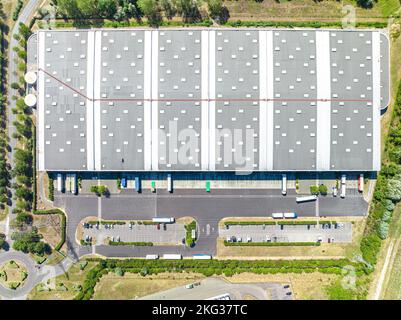 Top down shot of logistics center in industrial city zone from above. Stock Photo