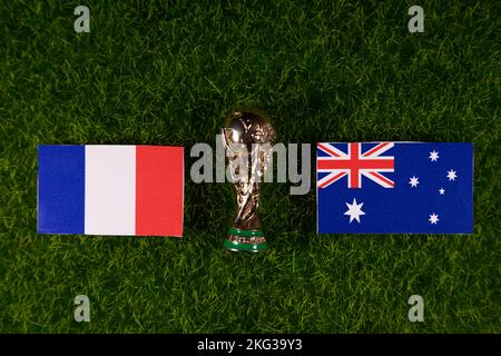 November 20, 2022, Doha, Qatar. Flags of Australia and France and the FIFA World Cup trophy on the green lawn of the stadium. Stock Photo