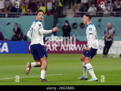 England's Jack Grealish celebrates scoring his sides sixth goal with Phil Foden during the FIFA World Cup Group B match at the Khalifa International Stadium, Doha. Picture date: Monday November 21, 2022. Stock Photo