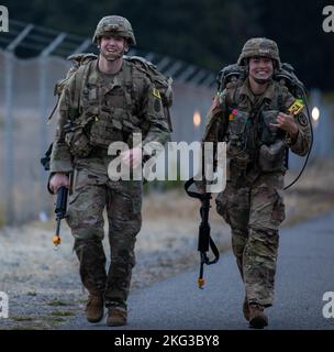 U.S. Army 1st Lt. Austin Pinkerton and 1st Lt. Molly Murphy perform the ruck march event as part of Medical Readiness Command, Pacific's Fiscal Year 2023 Best Medic Competition, Oct. 27, 2022 at Joint Base Lewis-McChord, Wash. Eight top Soldiers from across MRC,P competed in ten events over three days including a 15-mile ruck march, water survival tests, marksmanship, combat casualty care, and more. Stock Photo