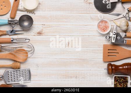 Various kitchen utensils on white wooden table top view with copy-space Stock Photo