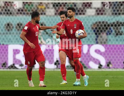Iran's Mehdi Taremi (right) celebrates after scoring from the penalty spot to give them their second goal during the FIFA World Cup Group B match at the Khalifa International Stadium in Doha, Qatar. Picture date: Monday November 21, 2022. Stock Photo