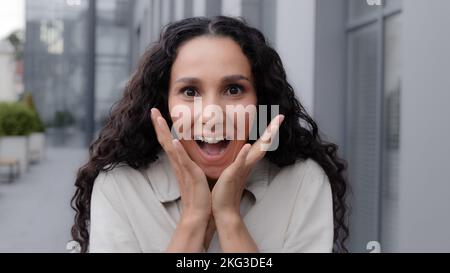 Hesdshot Oh my god wow female facial reaction close up. Amazed excited shocked wonder Caucasian woman girl raising hands in surprise unbelievable news Stock Photo