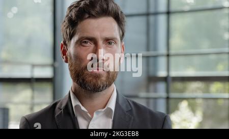 Portrait middle-aged male boss employer adult calm confident Caucasian 40s bearded man looking at camera marketing financial company CEO leader Stock Photo