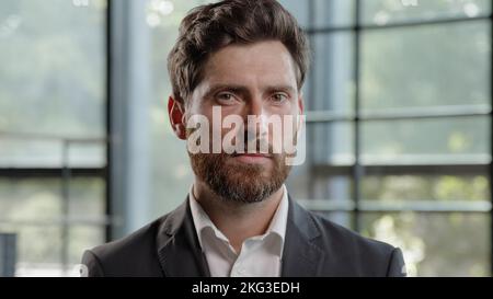 Business portrait in office serious calm middle-aged male boss employer adult Caucasian 40s bearded man looking at camera CEO leader trader male Stock Photo