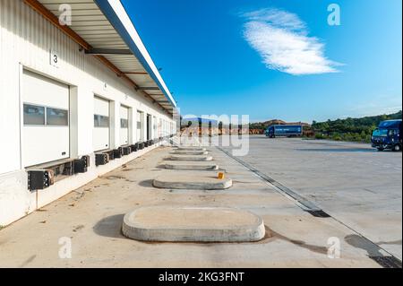 Perspective shot of warehouse sectional gates of the distributed center for loading and unloading cargo in a areas for trucks Stock Photo