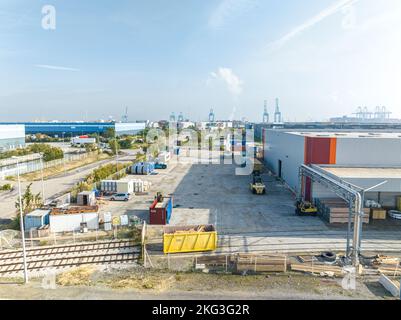 Drone shot of industrial economic zone featuring goods ready for delivery through vehicles in outside area Stock Photo