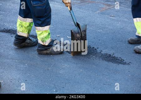 asphalt in wheelbarrow operator prepares mixture with uniform Stock ...