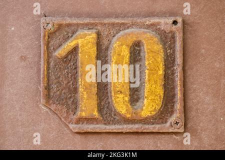 Old retro weathered cast iron plate number 10 closeup Stock Photo